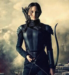 Picture of actress Jennifer Lawrence in her role as Katniss Everdeen holding a bow and arrow in dark clothing.