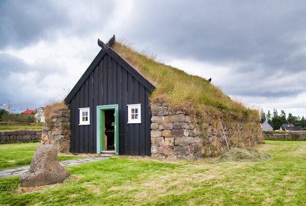 The outdoor Arbaer Museum displays what ancient buildings looked like. A stone building covered in grass.