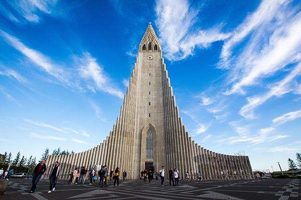 Full view of a beautiful church with a bright blue sky above it.