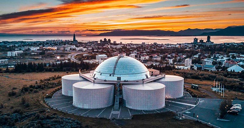 Aerial view of the famous Perlan Museum during sunset.