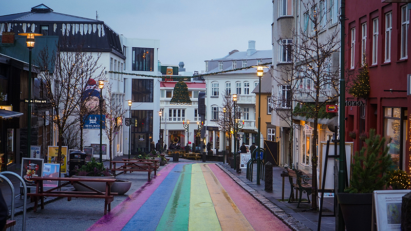 City street with a rainbow colored street.