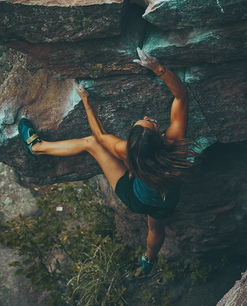 Woman climbing a steep mountainside