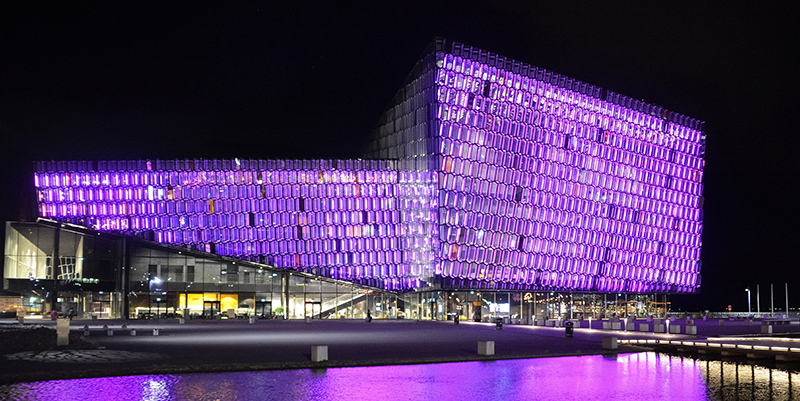 Picture of a building at night with purple lighting